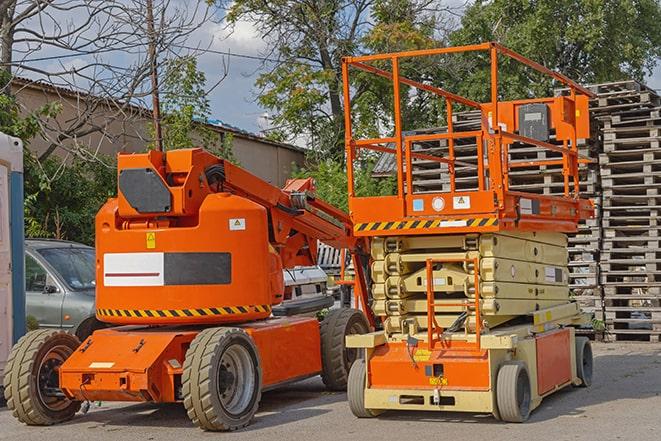 forklift carrying heavy pallets in warehouse in Commack